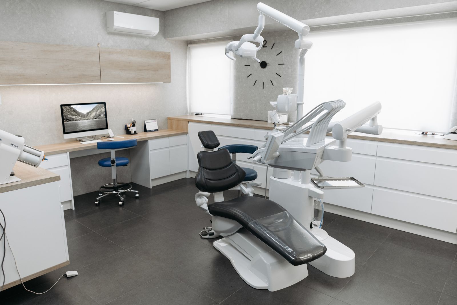 The Vantara Dental operatory — warm wood finishes, soft daylight, and contemporary clinical equipment